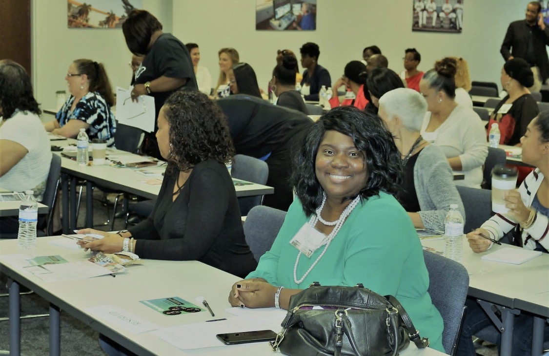 Community members collaborating around a table at SONC